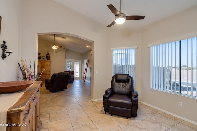 sitting room featuring lofted ceiling, light tile patterned floors, and ceiling fan