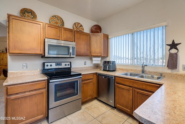 kitchen featuring sink, light tile patterned flooring, and appliances with stainless steel finishes