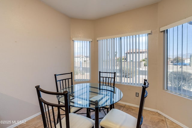 dining space featuring light tile patterned floors and a wealth of natural light