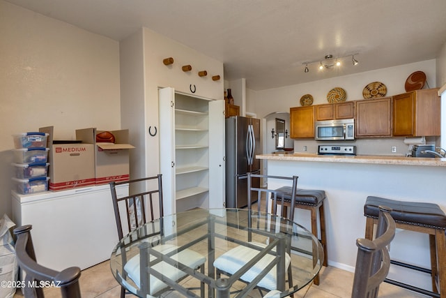 tiled dining area featuring sink