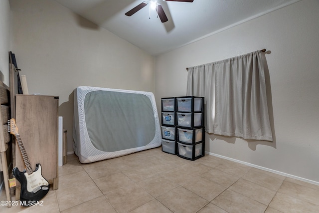 tiled bedroom with lofted ceiling and ceiling fan