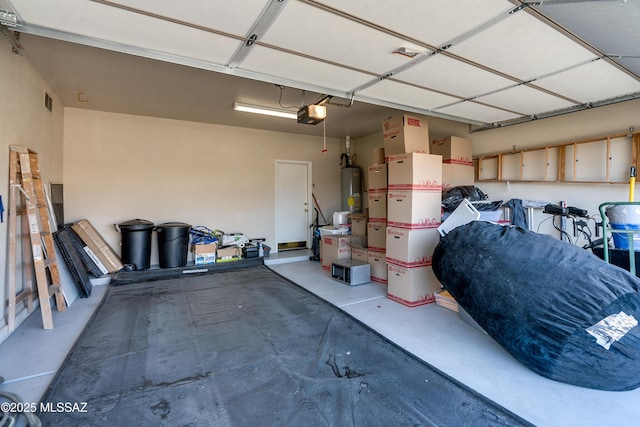 garage with a garage door opener and water heater