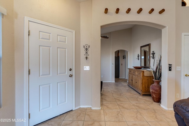 tiled entryway featuring a high ceiling