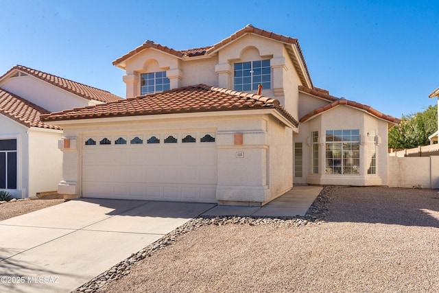 mediterranean / spanish house with a garage