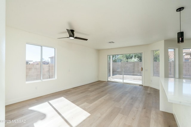 unfurnished room with light hardwood / wood-style floors and ceiling fan