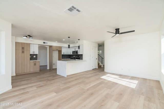 kitchen featuring ceiling fan, light hardwood / wood-style flooring, hanging light fixtures, and white cabinets