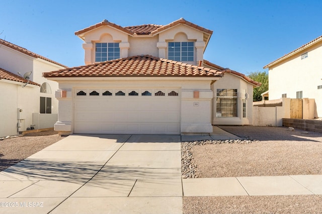 mediterranean / spanish house featuring a garage