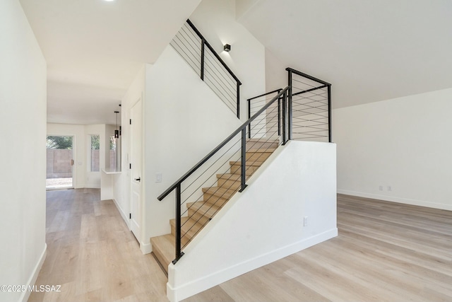 stairway featuring wood-type flooring