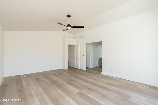 spare room with ceiling fan, lofted ceiling, and light hardwood / wood-style flooring