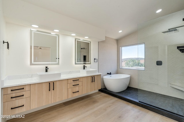 bathroom featuring vanity, shower with separate bathtub, and hardwood / wood-style floors