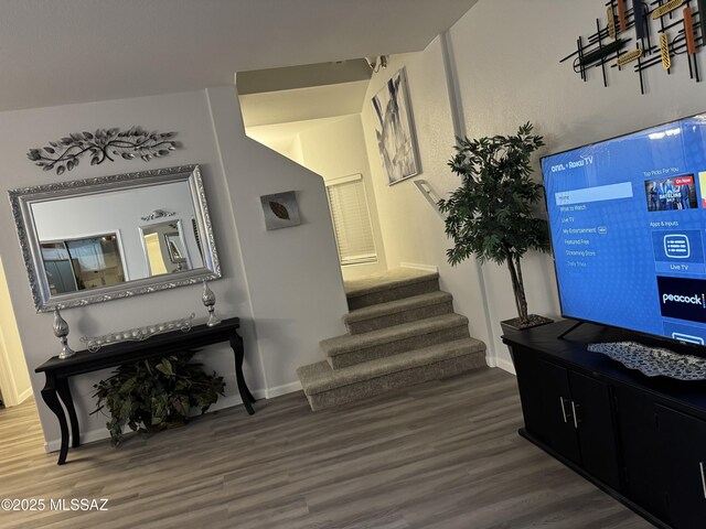 corridor with a notable chandelier and dark hardwood / wood-style floors