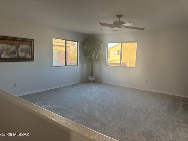 carpeted spare room with ceiling fan