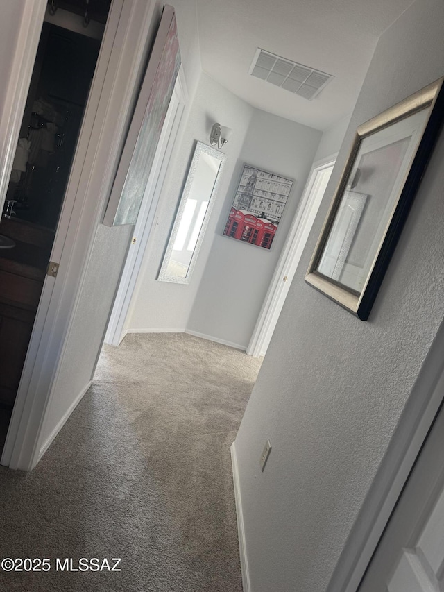 hallway with carpet flooring