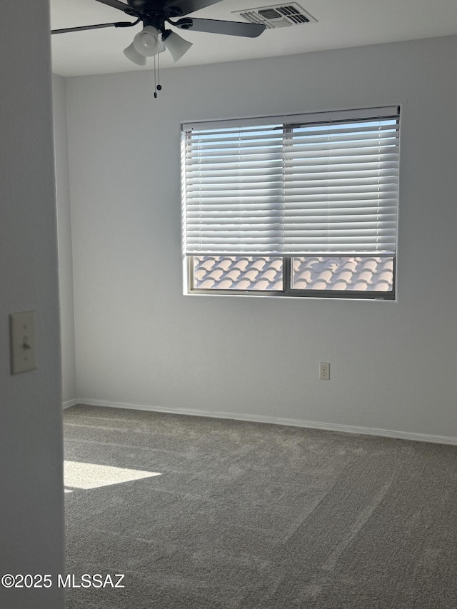 spare room with carpet and ceiling fan