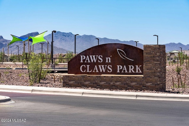 community sign with a mountain view