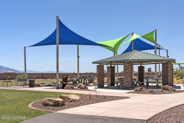 view of community featuring a gazebo, a mountain view, and a lawn