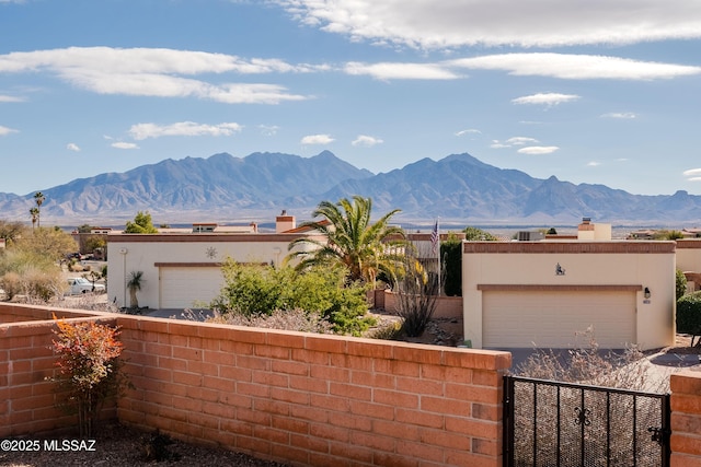 view of front facade featuring a garage and a mountain view