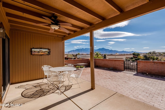 view of patio featuring a mountain view and ceiling fan