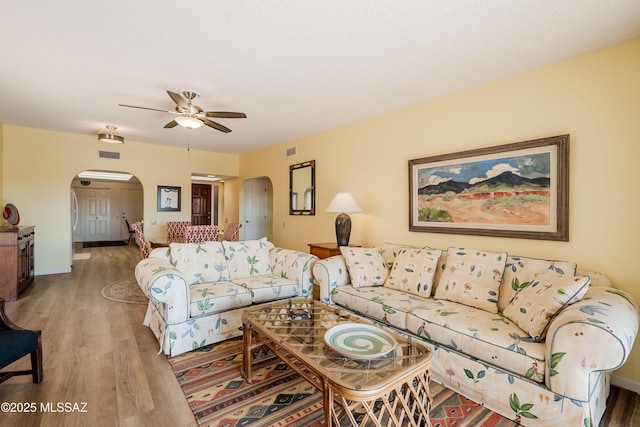 living room featuring hardwood / wood-style flooring and ceiling fan