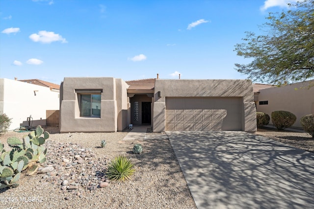 pueblo-style house featuring a garage