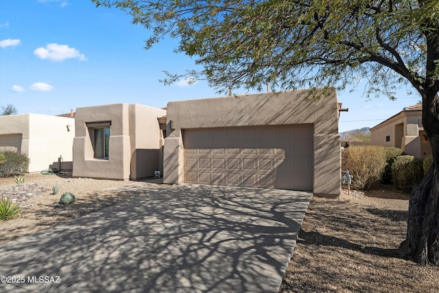 pueblo-style house featuring a garage