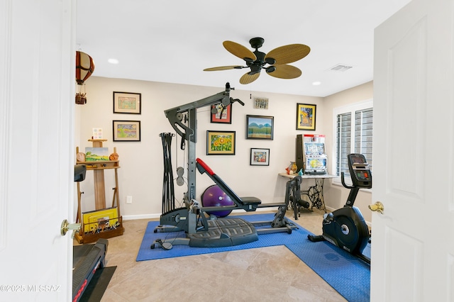 workout area featuring ceiling fan and light tile patterned floors