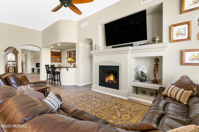 living room with high vaulted ceiling and ceiling fan