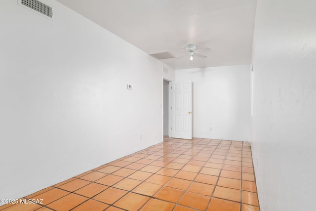 tiled spare room featuring ceiling fan