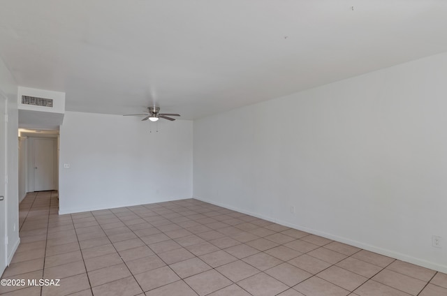 tiled empty room featuring ceiling fan