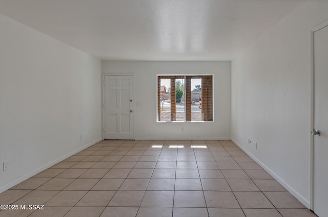 unfurnished room featuring light tile patterned floors