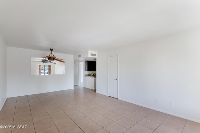 unfurnished room featuring light tile patterned flooring and ceiling fan