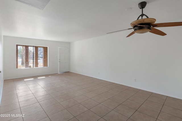 tiled empty room featuring ceiling fan