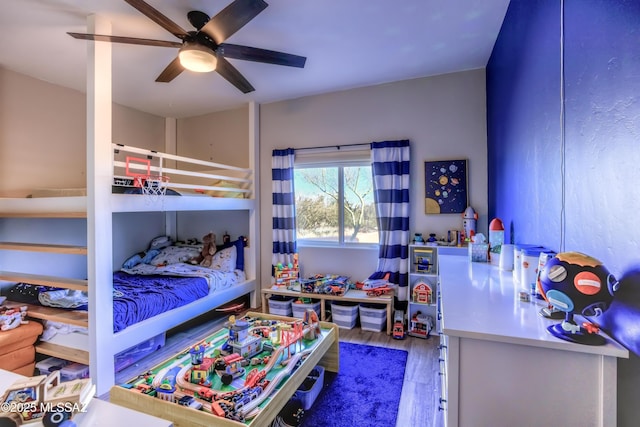 bedroom with hardwood / wood-style floors and ceiling fan