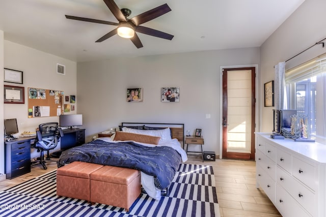 bedroom featuring multiple windows, ceiling fan, and light wood-type flooring