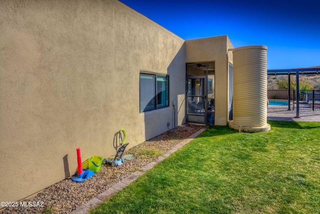 property entrance featuring a fenced in pool and a yard