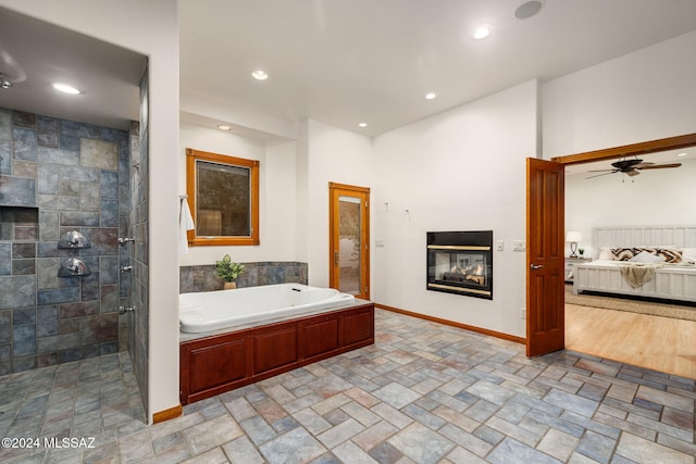 ensuite bathroom with a garden tub, recessed lighting, connected bathroom, a tile shower, and a multi sided fireplace