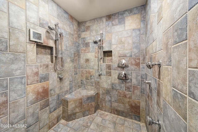 bathroom featuring a tile shower