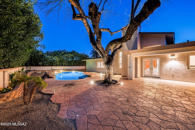 view of swimming pool featuring french doors, a patio area, and a fenced in pool