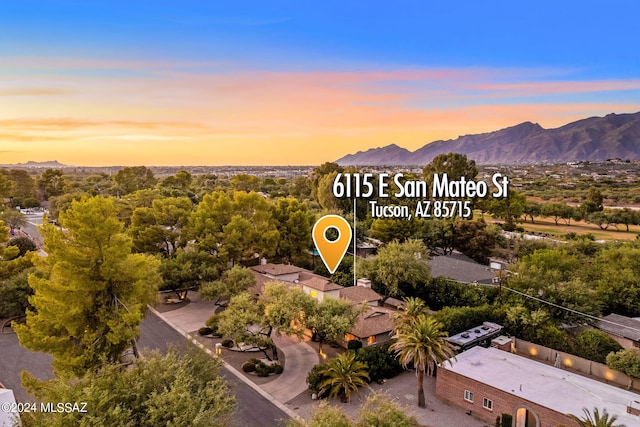 aerial view at dusk featuring a mountain view