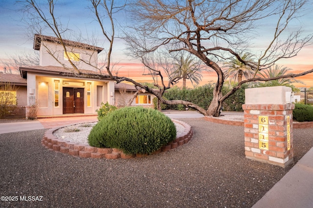 view of front of home with french doors and stucco siding