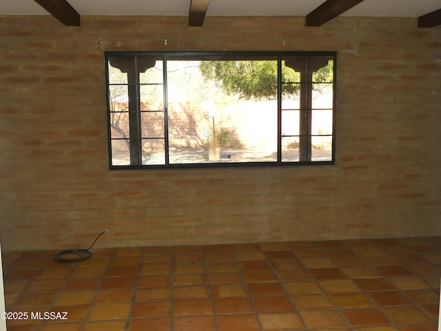 empty room with beamed ceiling