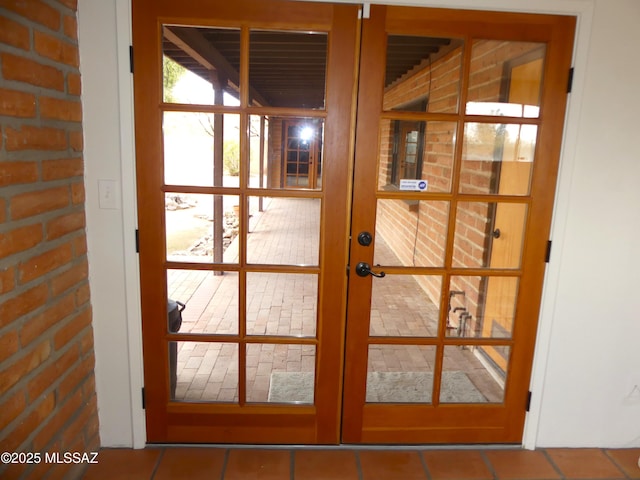 doorway to outside featuring tile patterned floors