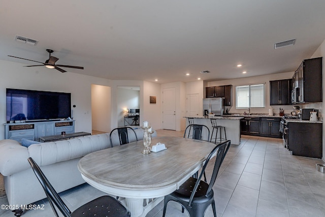 tiled dining area featuring ceiling fan