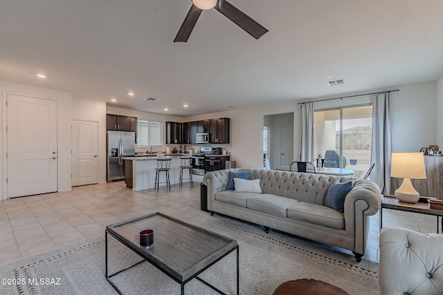 tiled living room featuring ceiling fan