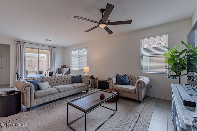 living room featuring light tile patterned floors and ceiling fan