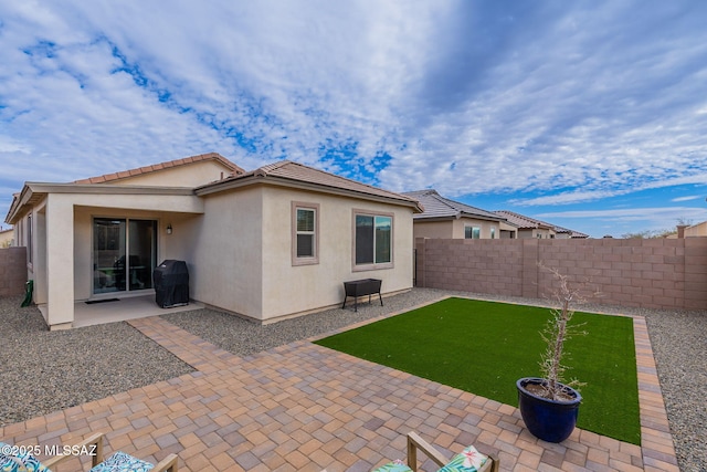 rear view of property featuring a patio area