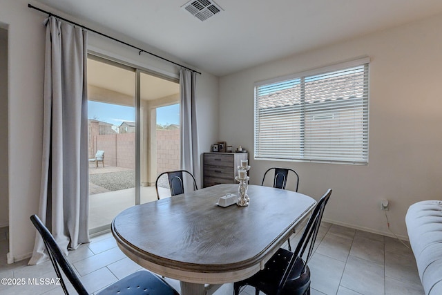 dining room with light tile patterned flooring and radiator