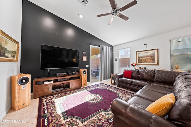 living room featuring ceiling fan, lofted ceiling, and light tile patterned floors