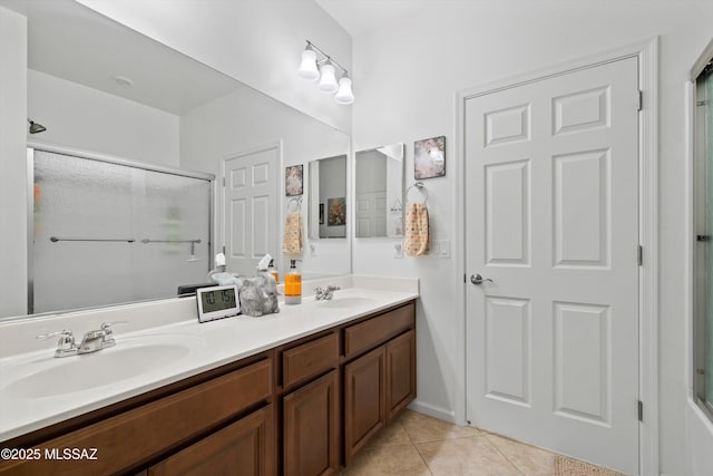 bathroom with tile patterned floors, an enclosed shower, and vanity