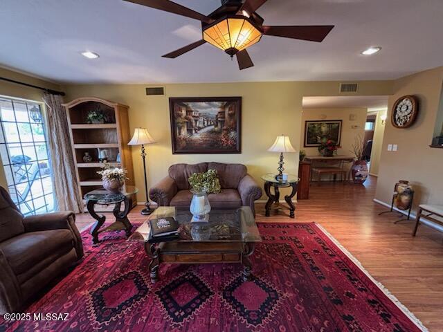 living room featuring hardwood / wood-style flooring and ceiling fan